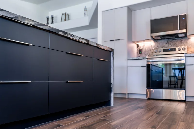 Custom navy island cabinetry and wood-look flooring in a finished Phoenix kitchen remodel