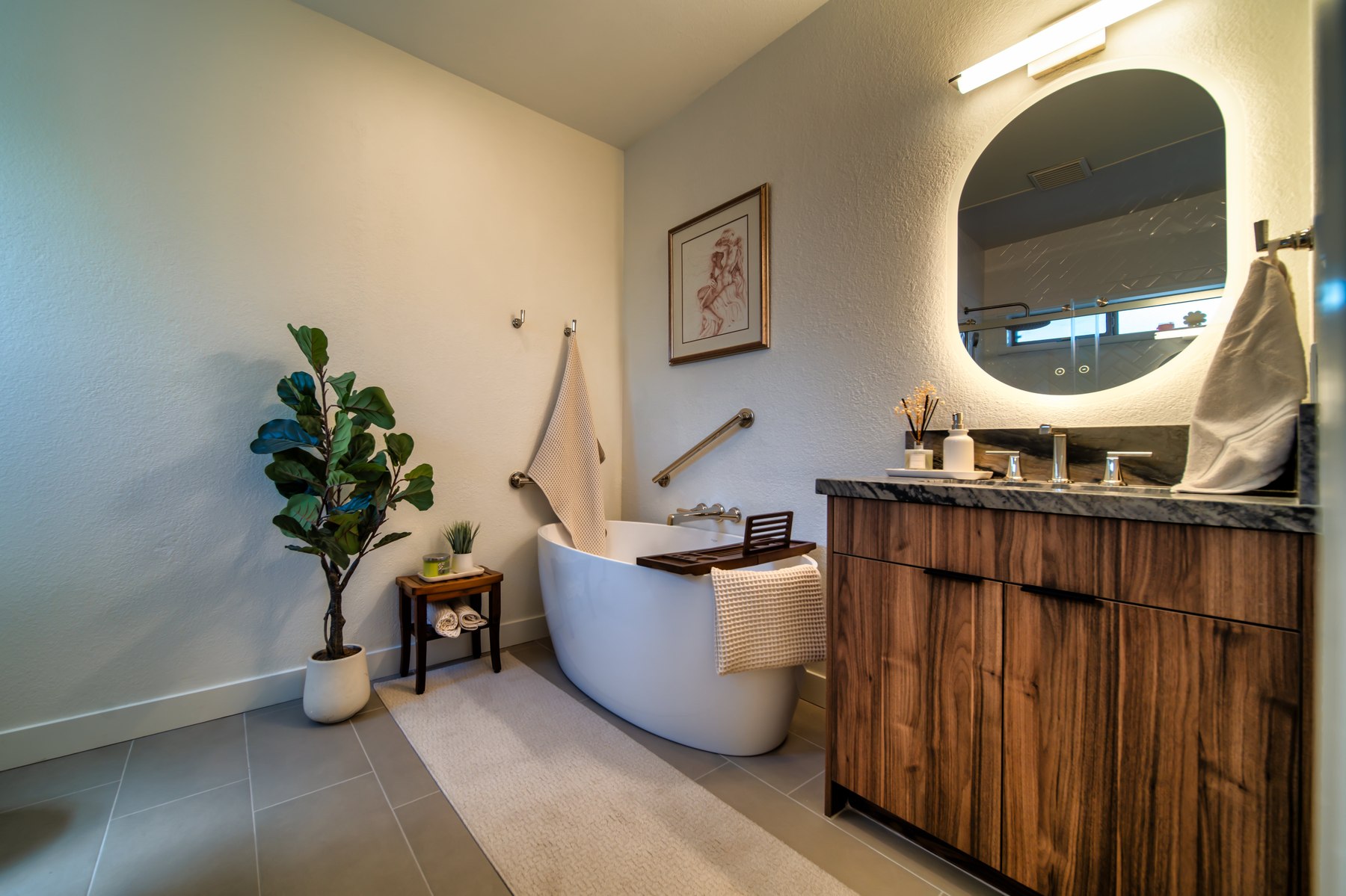 Freestanding soaking tub and walnut vanity in a Fountain Hills bathroom remodel