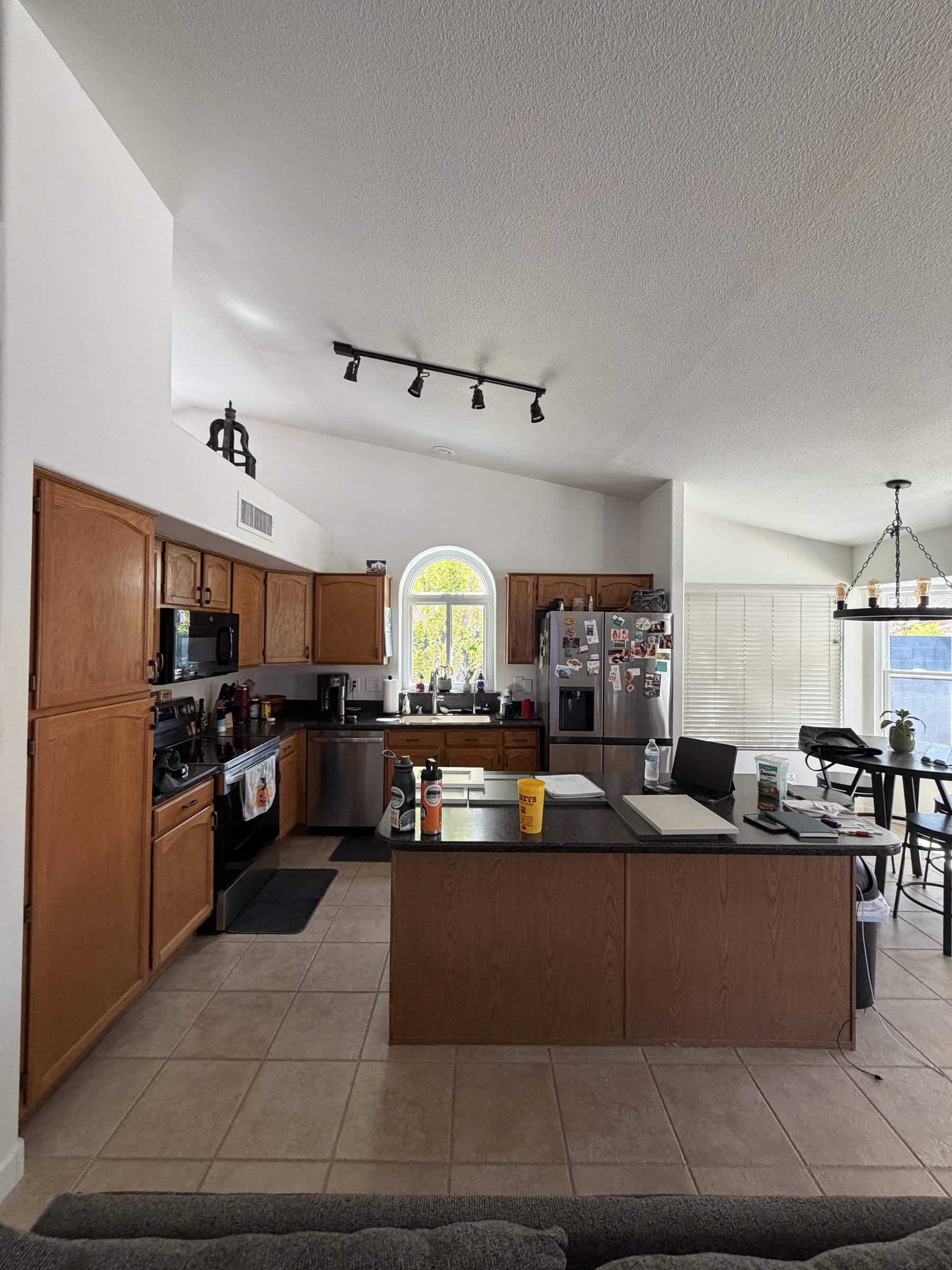 Original oak cabinetry and black appliances before Phoenix remodel