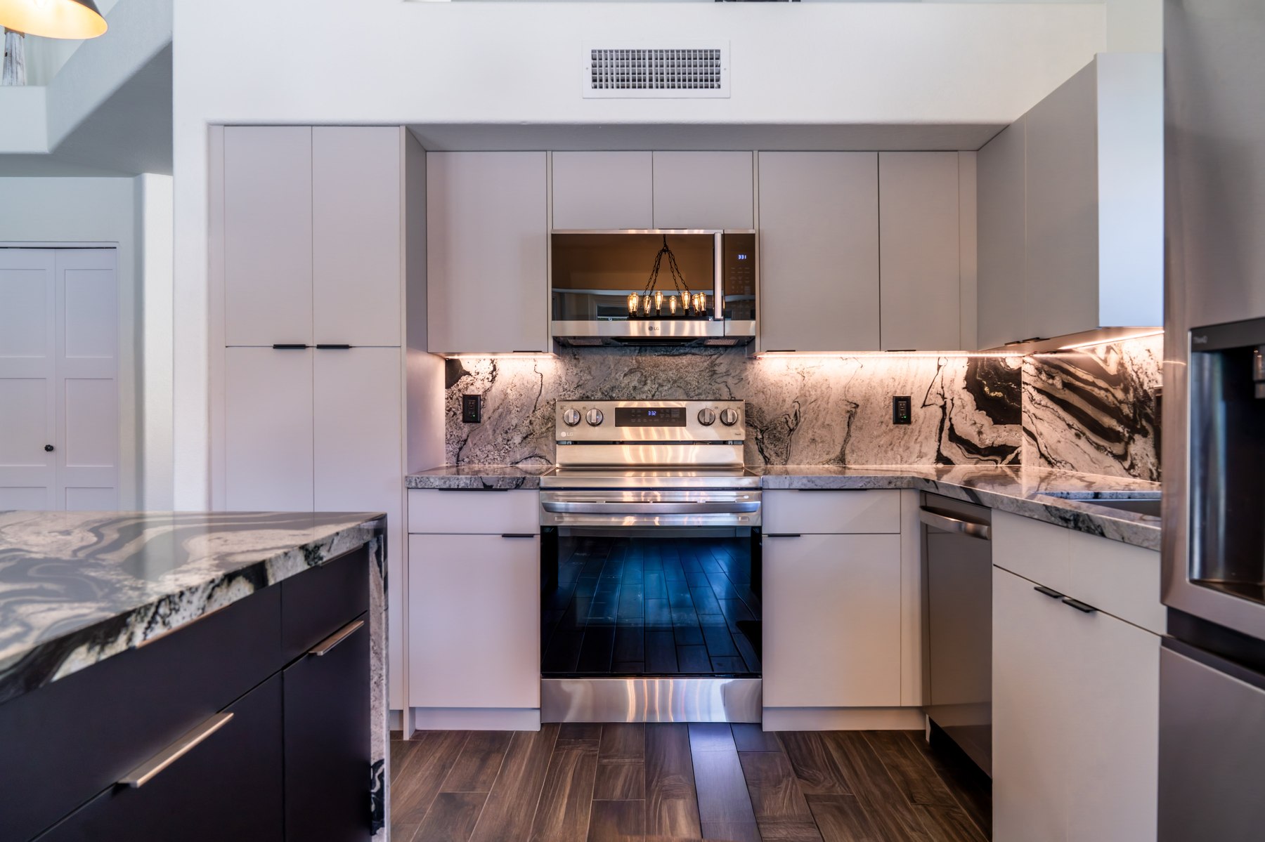 Finished range wall with book-matched stone backsplash, Phoenix remodel