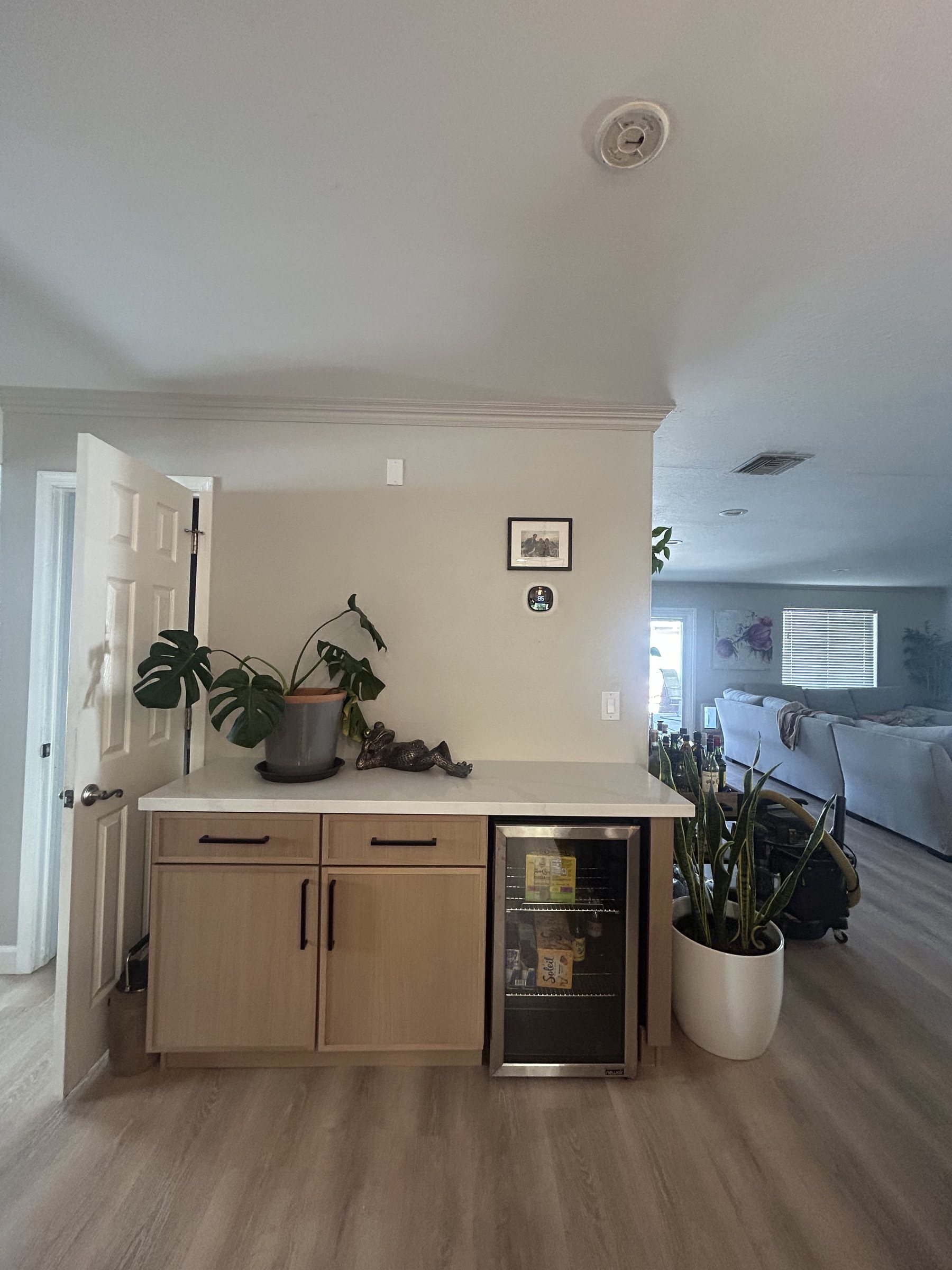 Finished custom dry bar with wine fridge and light wood cabinetry, Phoenix remodel