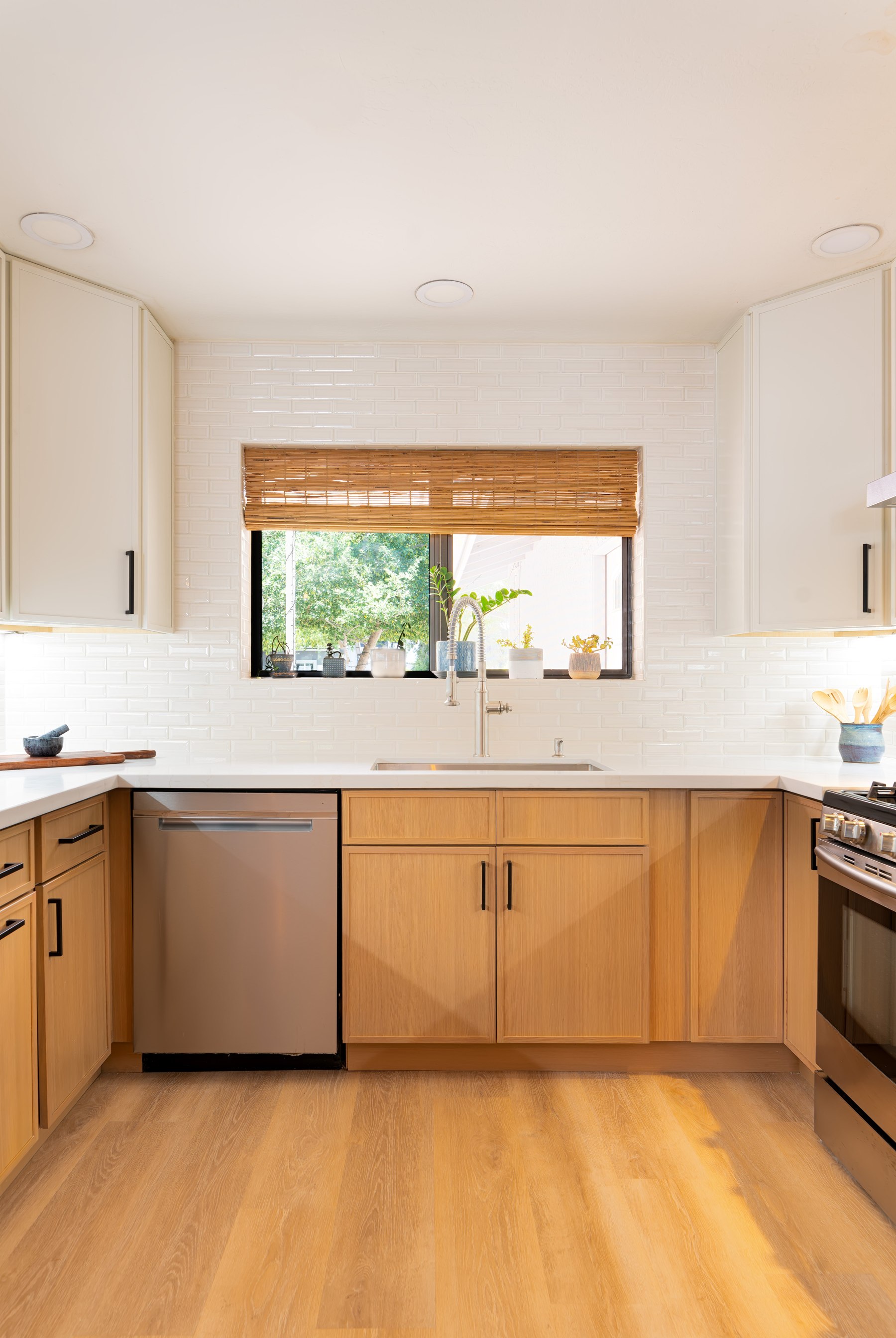 Wide view of the finished sink wall with range and dishwasher, Phoenix remodel