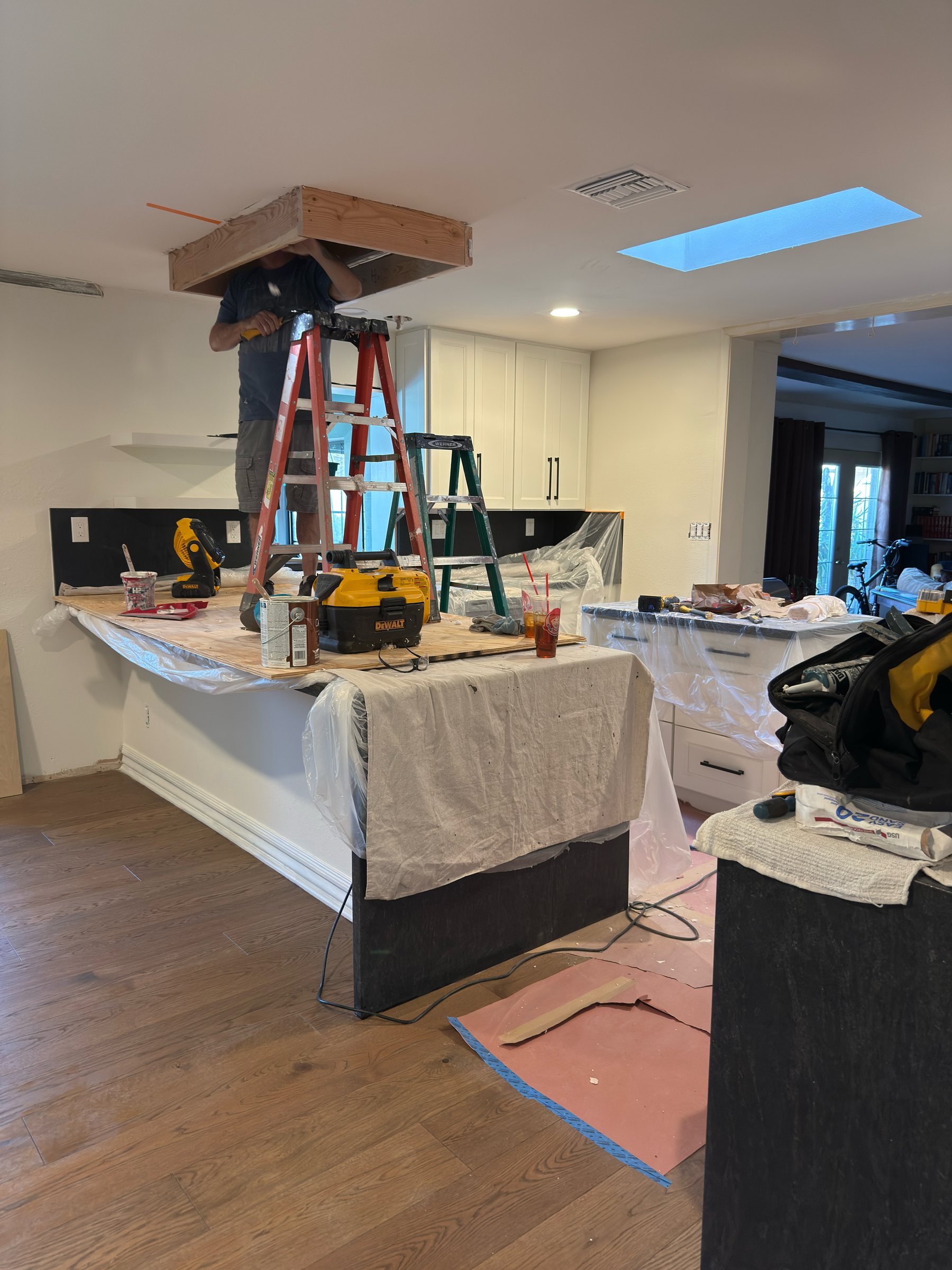 Range hood framing installed mid-renovation with new hardwood flooring underway, Scottsdale remodel