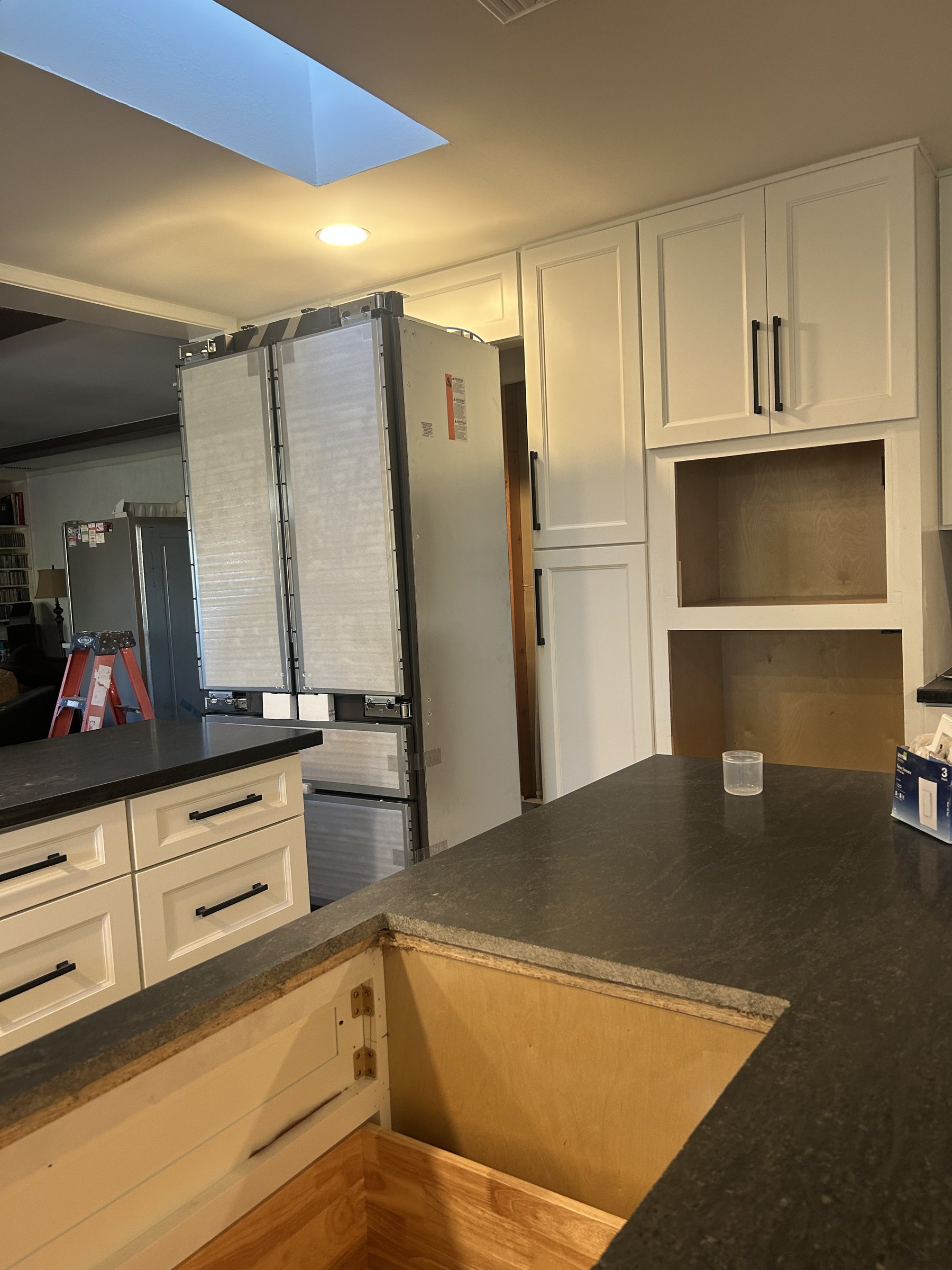 New white cabinetry installed with appliances still wrapped, Scottsdale remodel