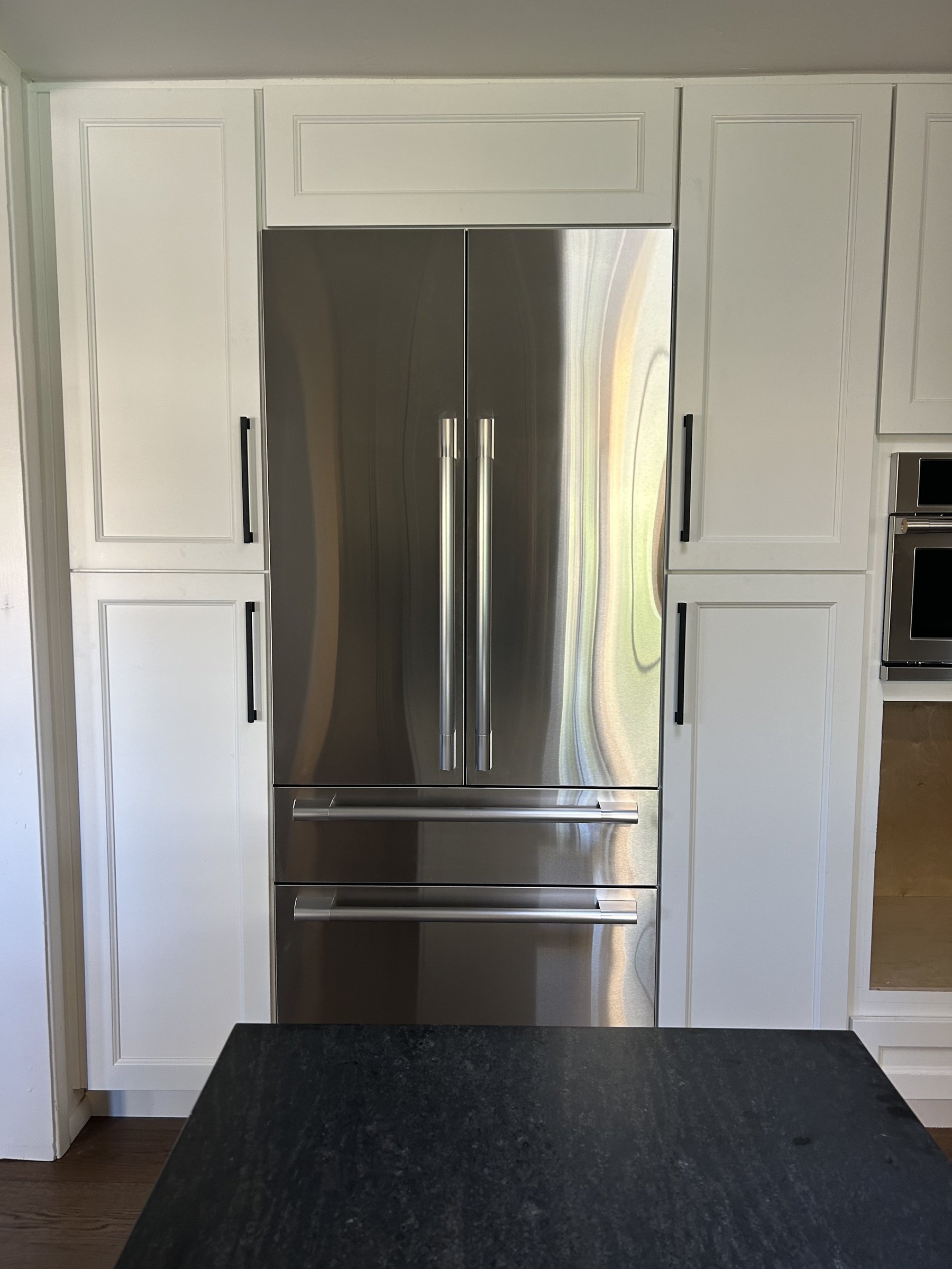 Built-in refrigerator integrated into white cabinetry, Scottsdale remodel