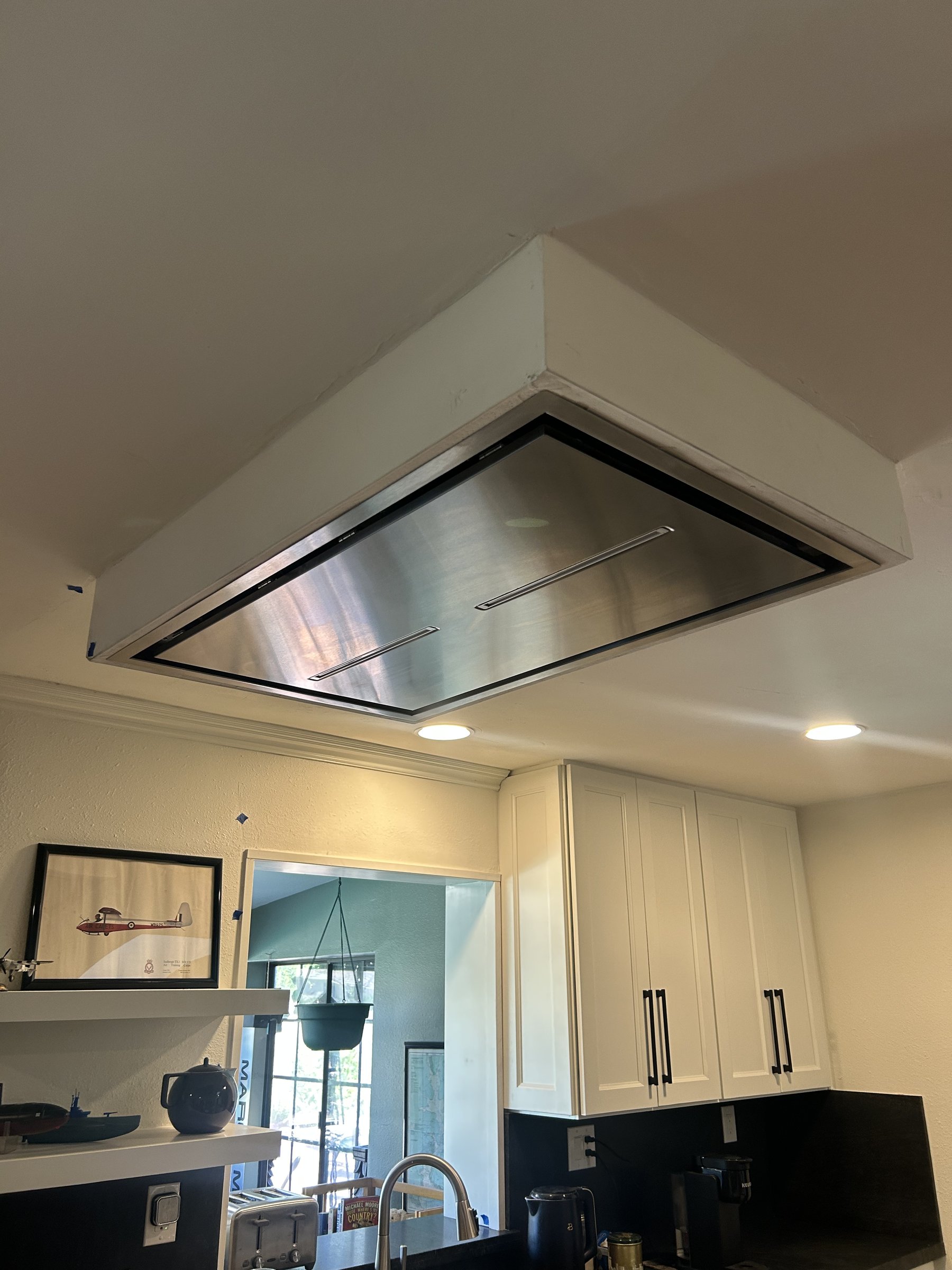 Detail view of the finished flush-mounted stainless range hood, Scottsdale remodel