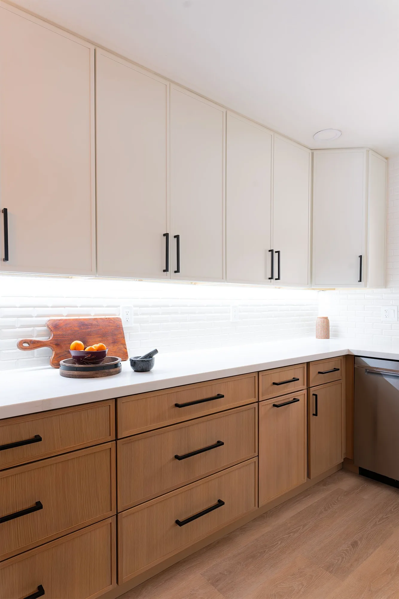 Two-tone custom cabinetry with black bar pulls in a Phoenix kitchen remodel